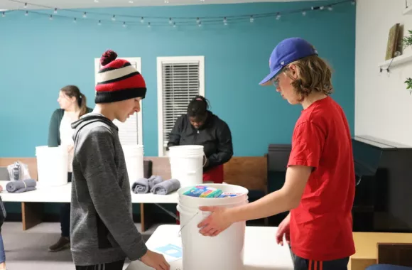Volunteers at McIvor Avenue Mennonite Brethren Church in Winnipeg, Manitoba, came together in November 2022 to pack relief kits for MCC as part of the Buckets of Thanks initiative.