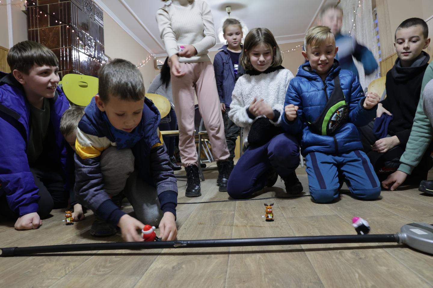 A group of children playing with toys in a shelter