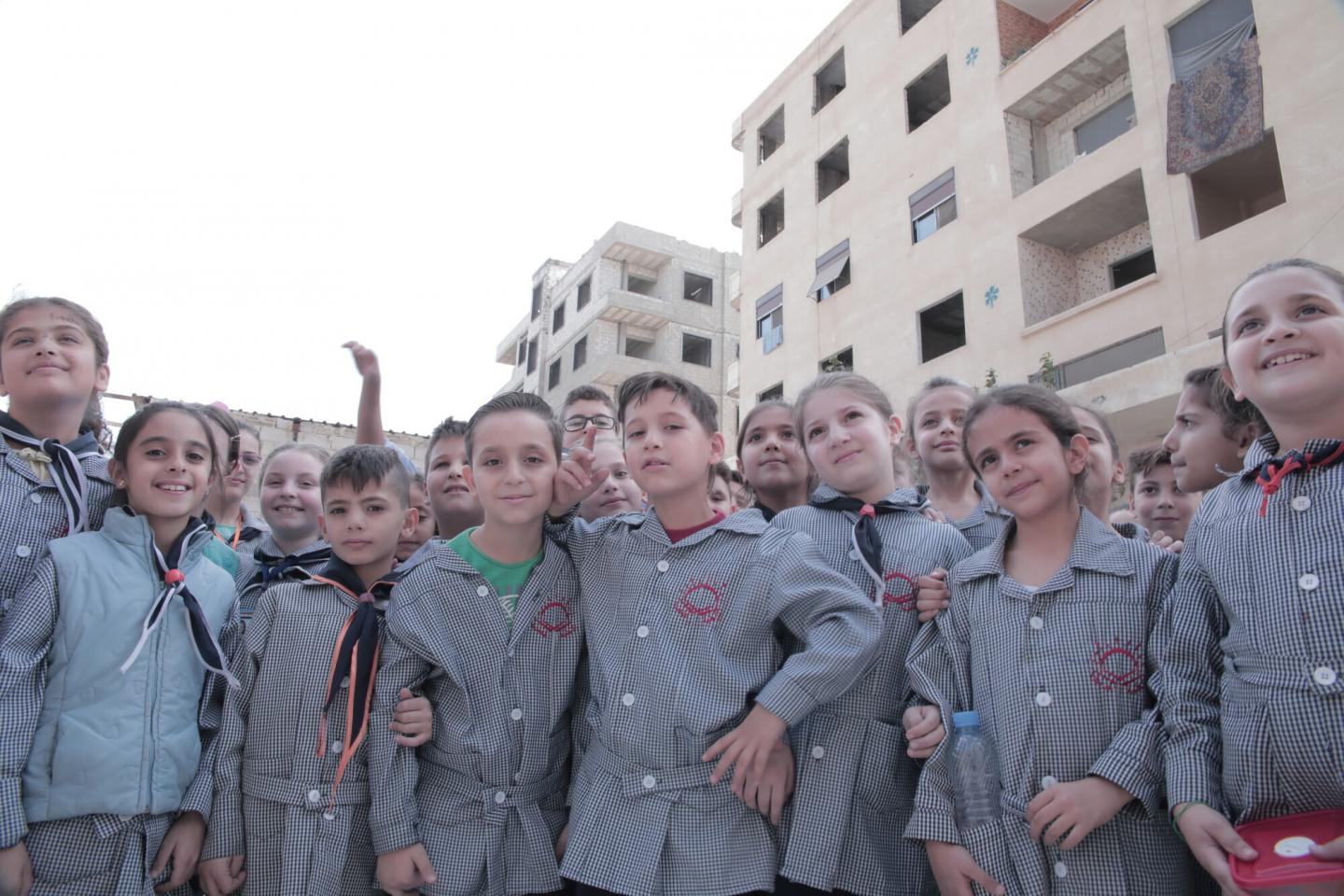 A large group of Syrian kids in school uniforms