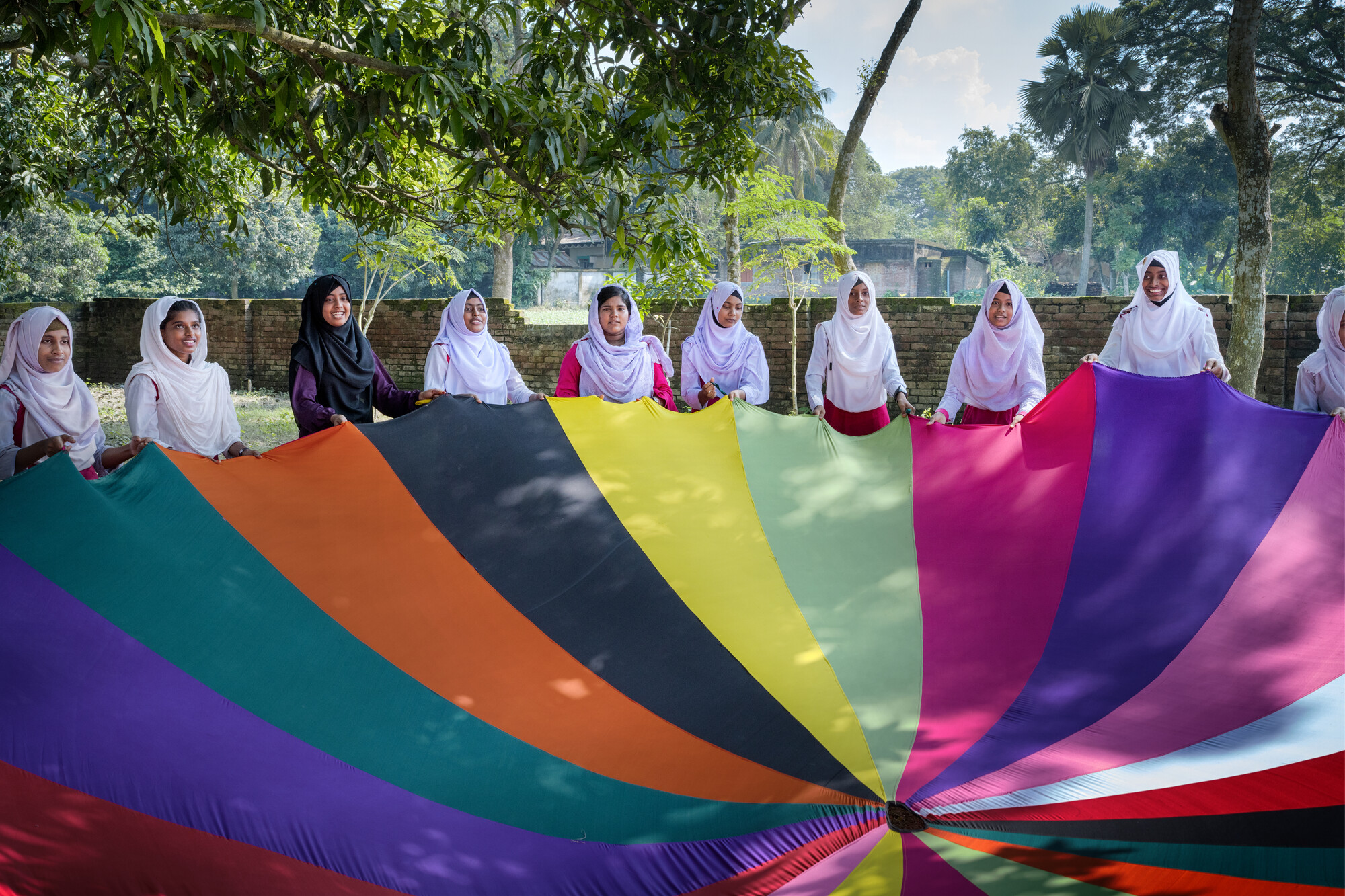 Girls play with a parachute