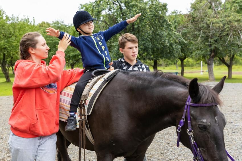 The 6-year-old child* on the horse is assisted during therapy for children who are displaced and affected by war.  

MCC, with partner Association of Mennonite Brethren Churches of Ukraine (AMBCU),