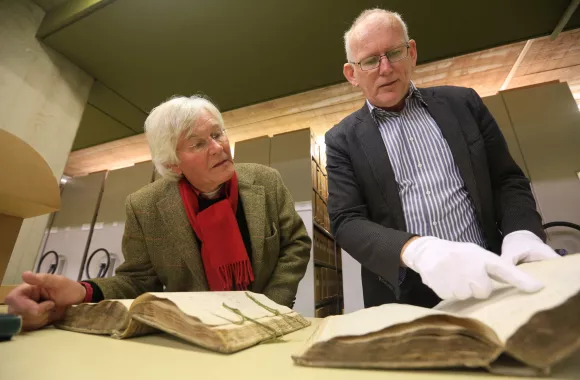 A man and woman examining historical records